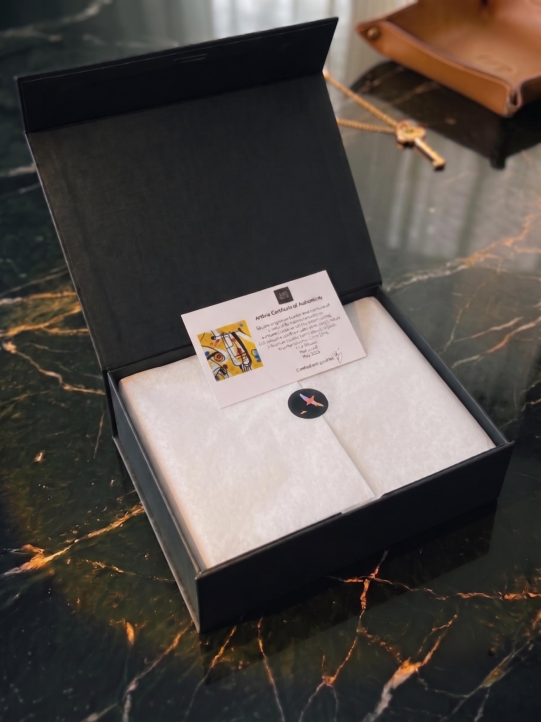 A boxed silk edition used to plan a measured scarf gallery-wall rotation