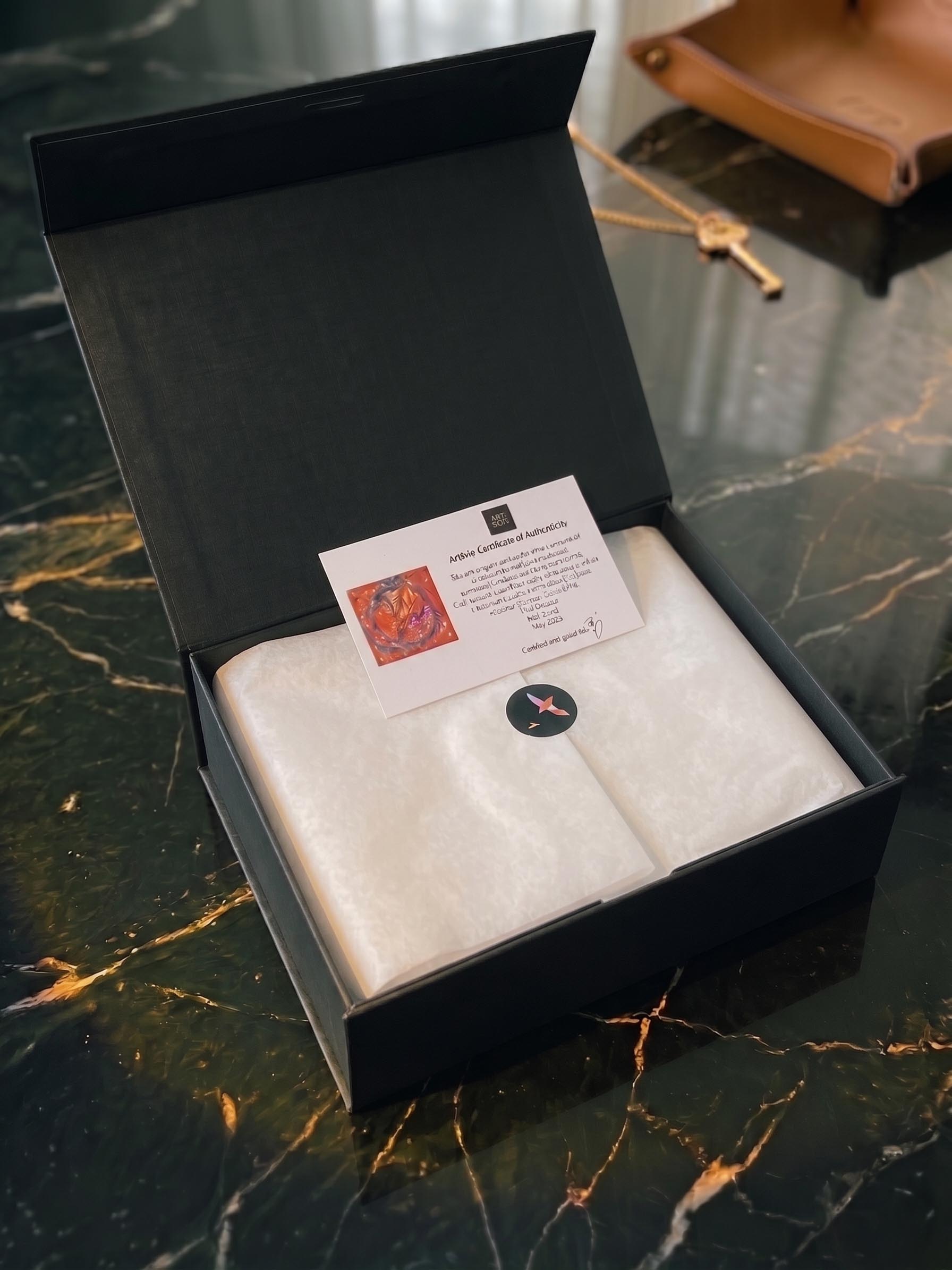 A boxed ArtSoie edition inviting a scarf collector into artist-authored silk art
